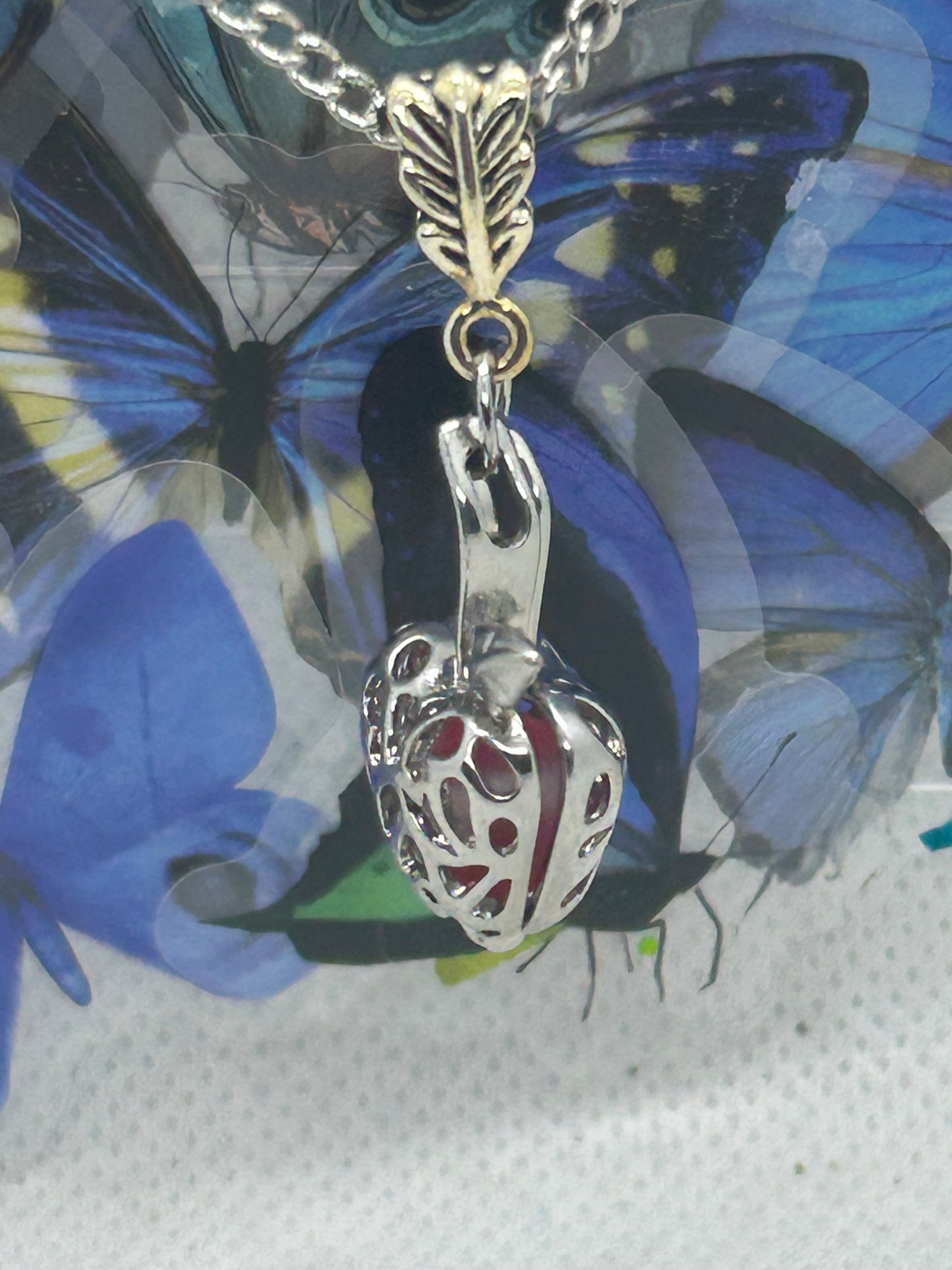 Red Glowing Mermaid bead incased in a Silver Apple Necklace