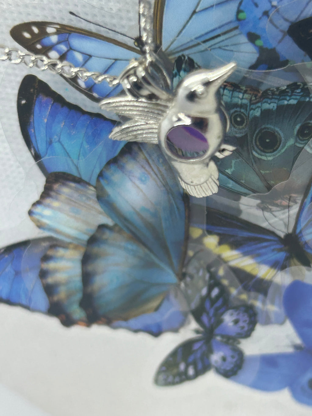 Humming Bird Necklace with an incased is a glowing bead