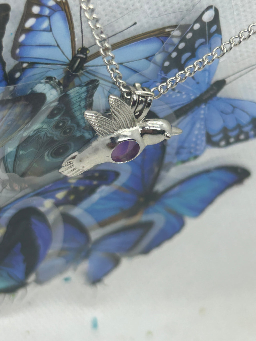 Humming Bird Necklace with an incased is a glowing bead