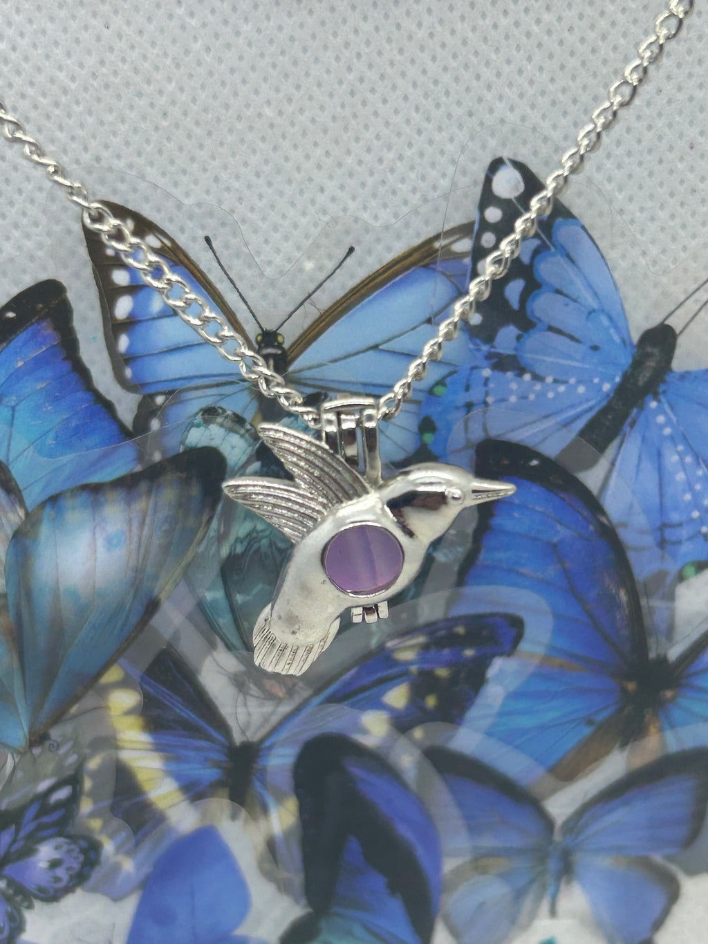 Humming Bird Necklace with an incased is a glowing bead
