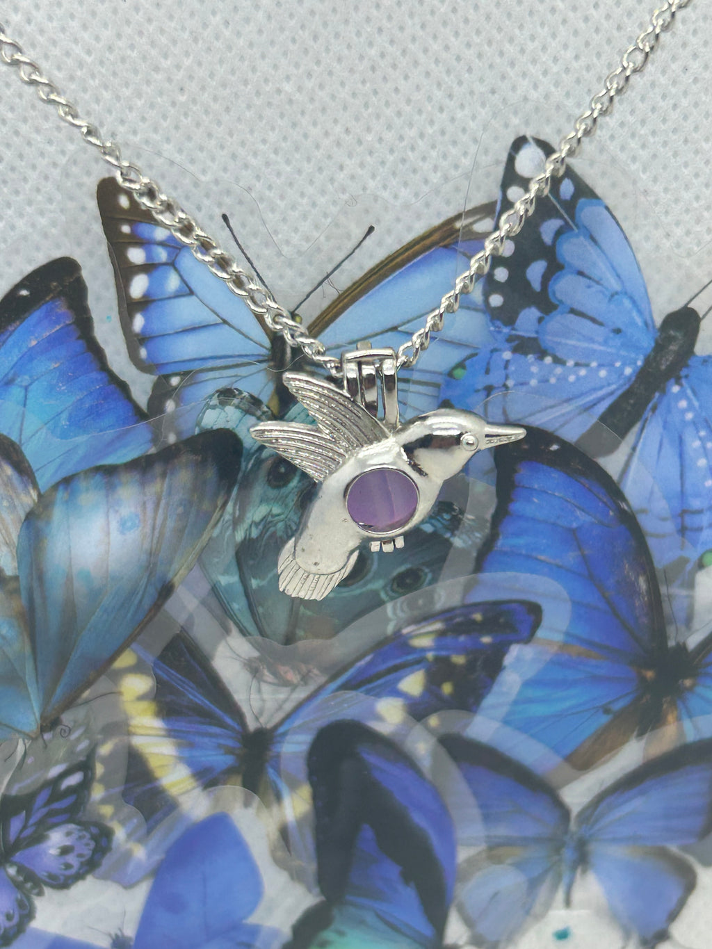 Humming Bird Necklace with an incased is a glowing bead
