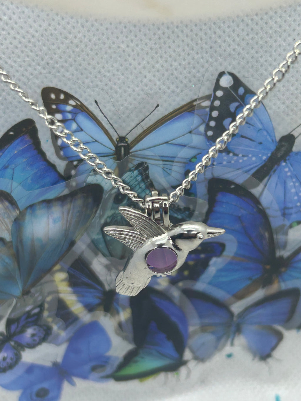 Humming Bird Necklace with an incased is a glowing bead